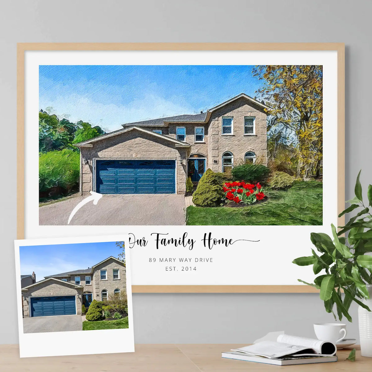 Oil-style portrait of a stone house with a blue garage door, in a light oak frame, with a small inset photo of the house