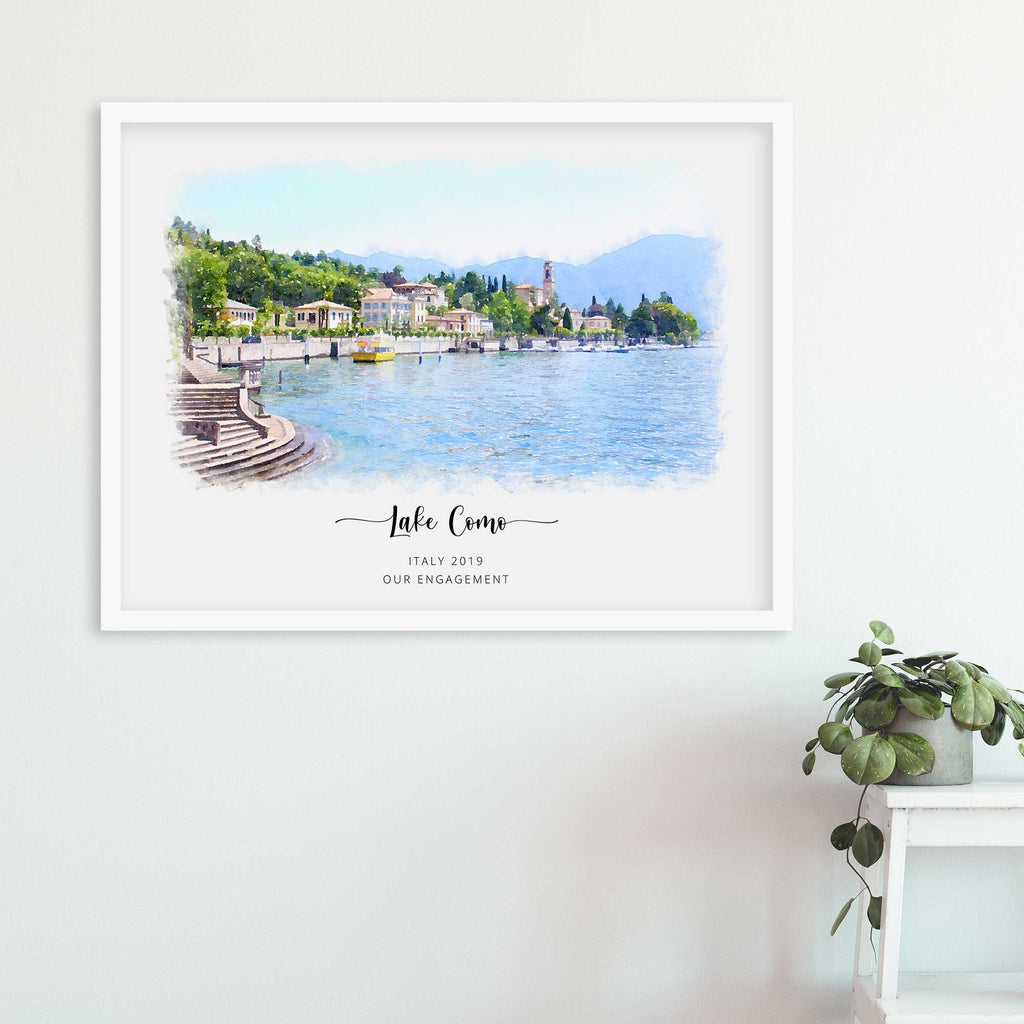Watercolor-style portrait of Lake Como with lakeside buildings and hills, framed in white, with 'Our Engagement' beneath