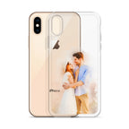 Clear iPhone X/XS case printed with a watercolor-style portrait of a couple embracing, beside a gold iPhone