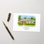 Postcard printed with a watercolor-style portrait of a white house, titled 'Our first home', beside a gold and black pen